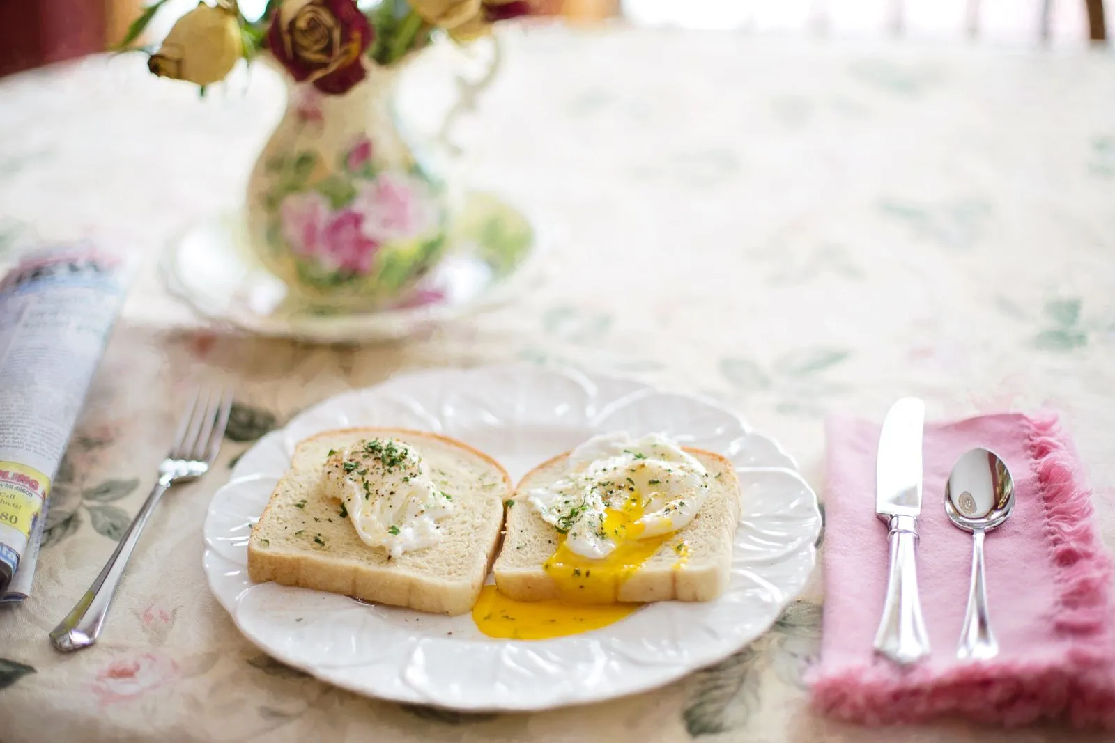 A cozy breakfast setting featuring poached eggs on toast with vintage decor.